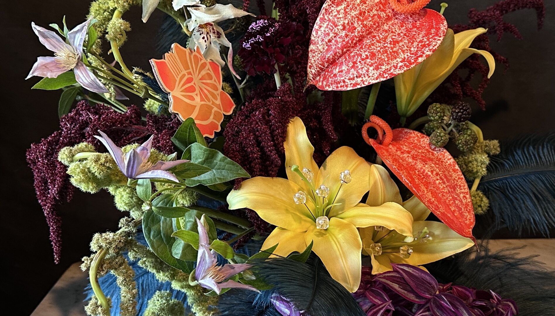 Photo of a flower arrangement against a black background.