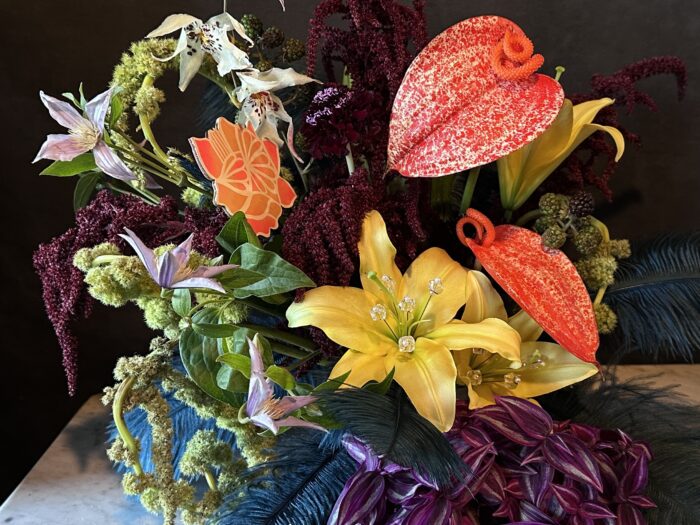 Photo of a flower arrangement against a black background.