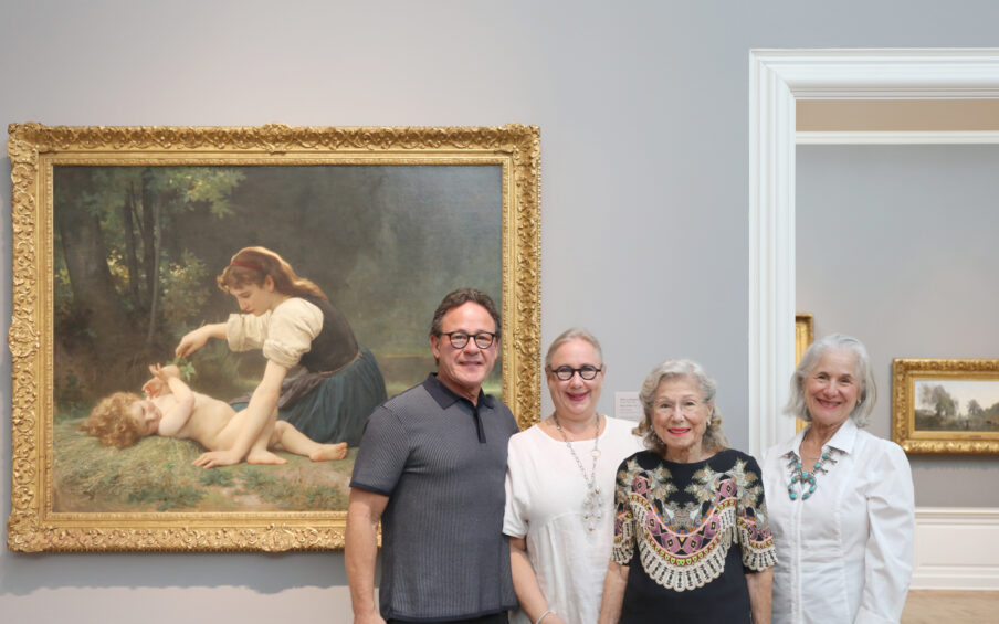 Stern family standing in front of Nature's Fan painting