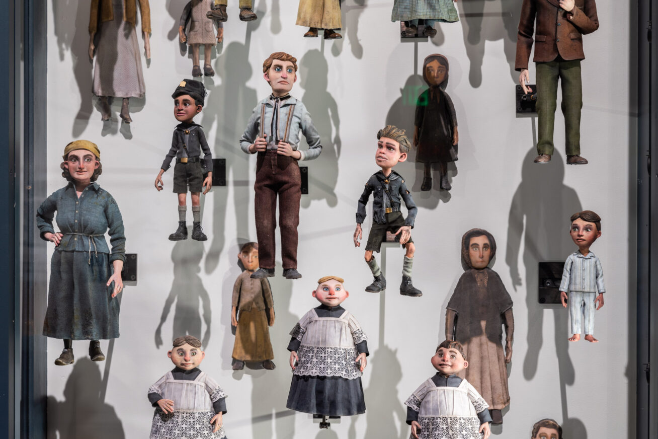 Photo of a display case filled with various puppets from the movie Guillermo del Toro's Pinocchio.