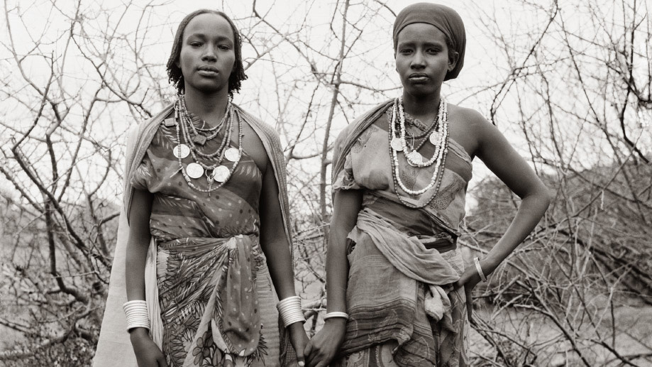 Black and white photo of two Black women holding hands