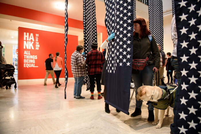 Low vision and blind Museum visitors experiencing artist Hank Willis Thomas’s “14,719.”