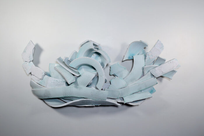 Porcelain sculpture of a deconstructed jar glazed light blue