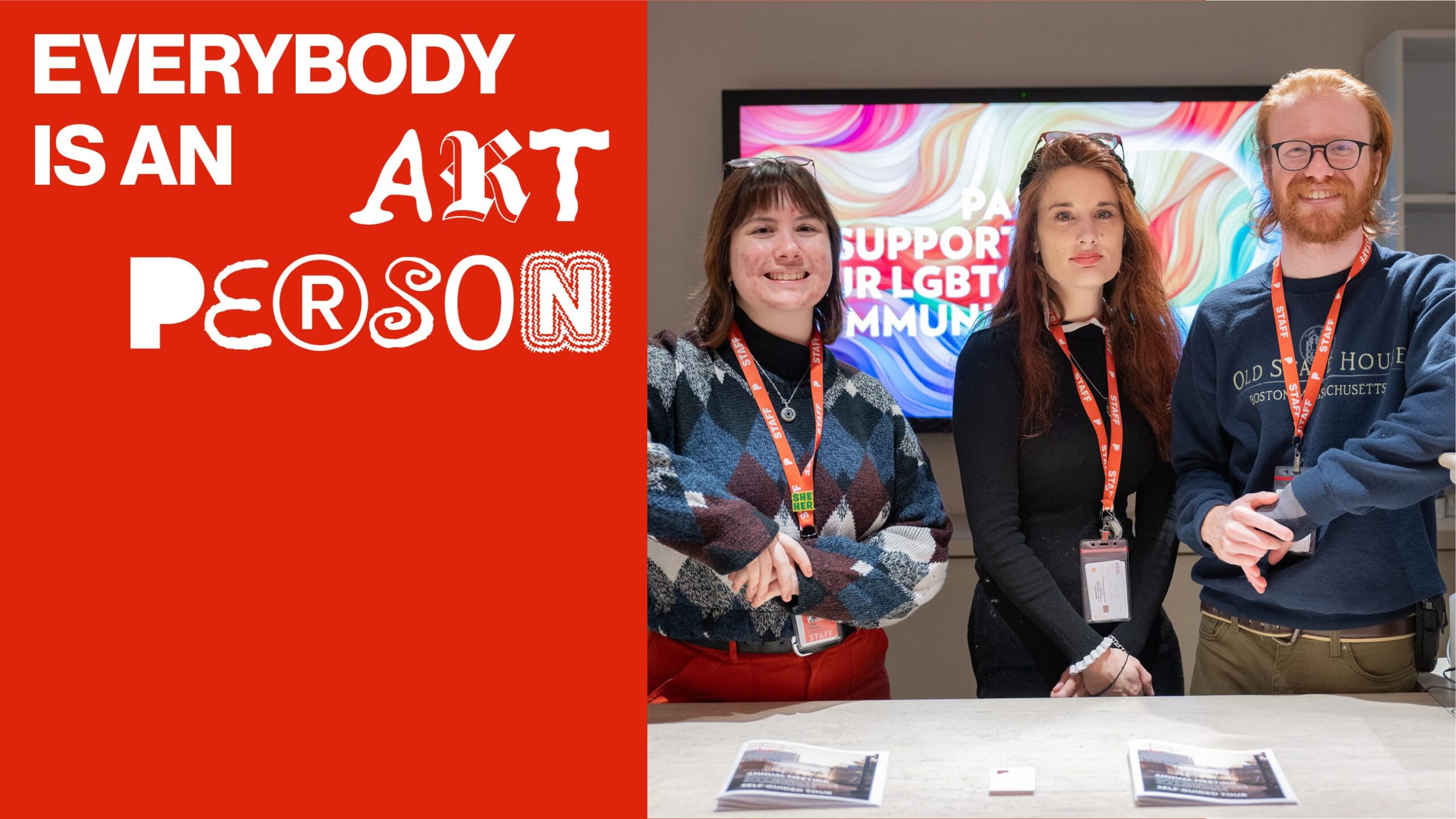 Everybody is an Art Person. Three people standing behind a desk.