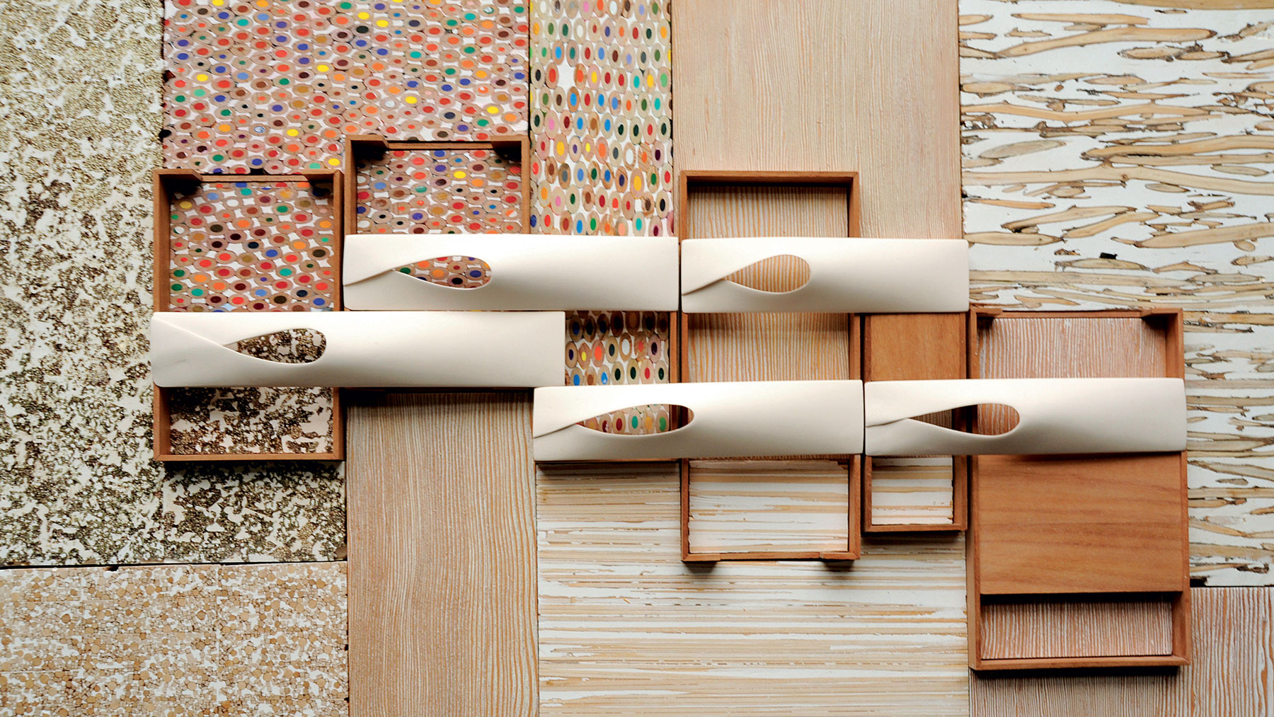 Photo of an arrangement of wood, colored pencils, plaster, and porcelain.