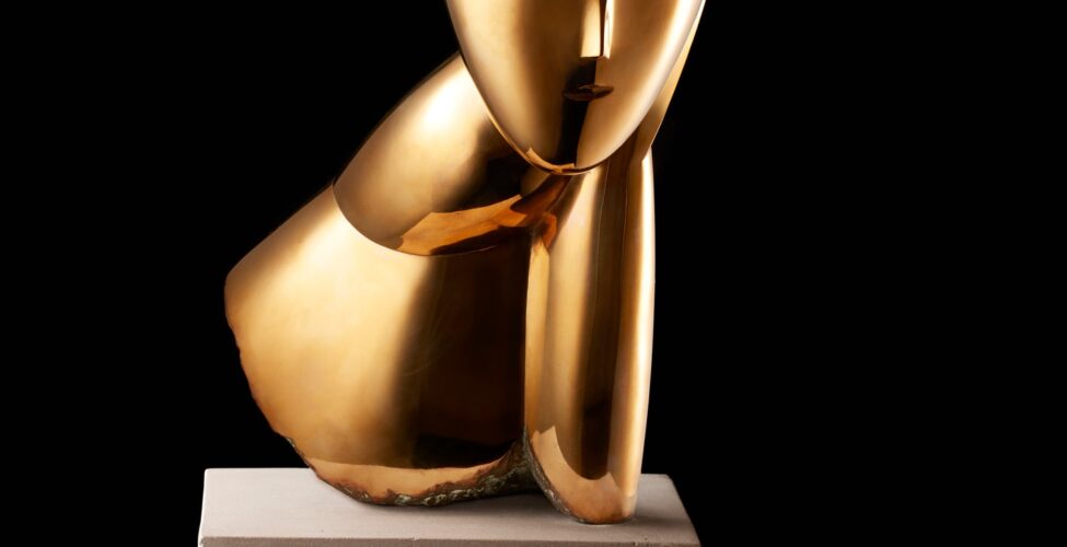 Image description: Muse, Constantin Brancusi, bronze on limestone base, 19 1/2 x 10 x 5 inches. A smooth, bronze, stylized bust of a woman’s head, elongated neck and shoulder. Front view: The woman’s egg-shaped head is smooth except for a raised V shape in the center representing the brow and finishing in a delicate nose. A small mouth is the only other feature on the face. Hair is suggested with rough, textured lines incised into the crown of the head. This texture appears darker than the glossy golden bronze face. A long neck extends from the head at left and is attached to a sloping shoulder. At right, the head seems to rest on a hand and forearm that extends to join the shoulder. The bottom edge of the sculpture has a rough and unfinished appearance. The bust rests on a gray cube of limestone that is juts a bit wider than the sculpture and about half as high. Left profile view: A smooth egg-shaped head smooth except for a small nose at the lower third of the profile. An simple C shaped ear is positioned below the textured hair. A gracefully shaped neck extends forward from a wedge-shaped shoulder. The bronze material folds back on itself, exposing rough edges, to rest on the base. Rear view: The textured hair appears to lengthen past the shoulder area ending in a blunt point. The sculpture’s shoulders fan out into a cone like structure that opens at an angle to expose the unpolished bronze inside. Right profile view: The hand and forearm shapes are visible from this view represented by simple elongated oval shape, a crease at the wrist giving definition to the two parts.