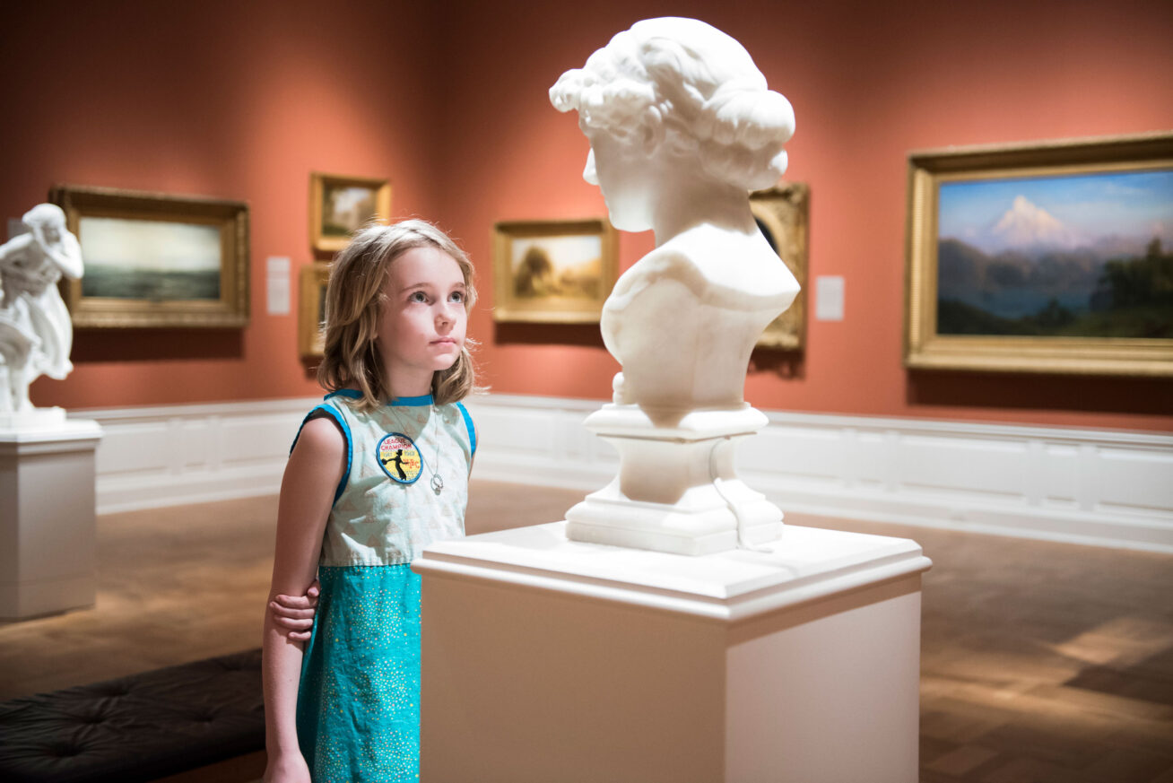 A young person viewing a sculpture.