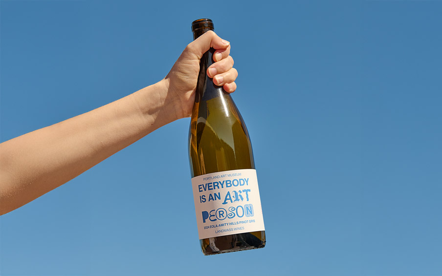 A hand holding a bottle of wine with the text Everybody is an Art Person.