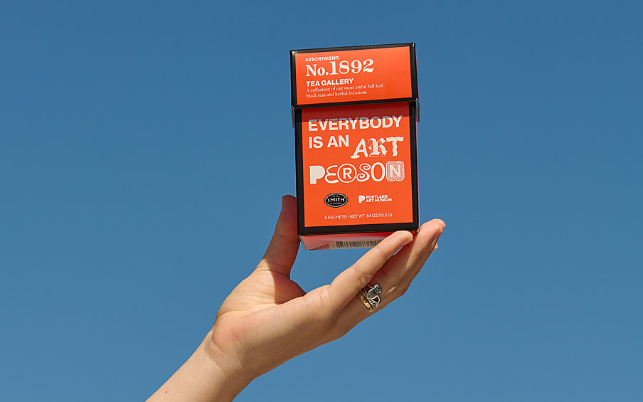 A hand holding up a box of tea with the text Everybody is an Art Person.