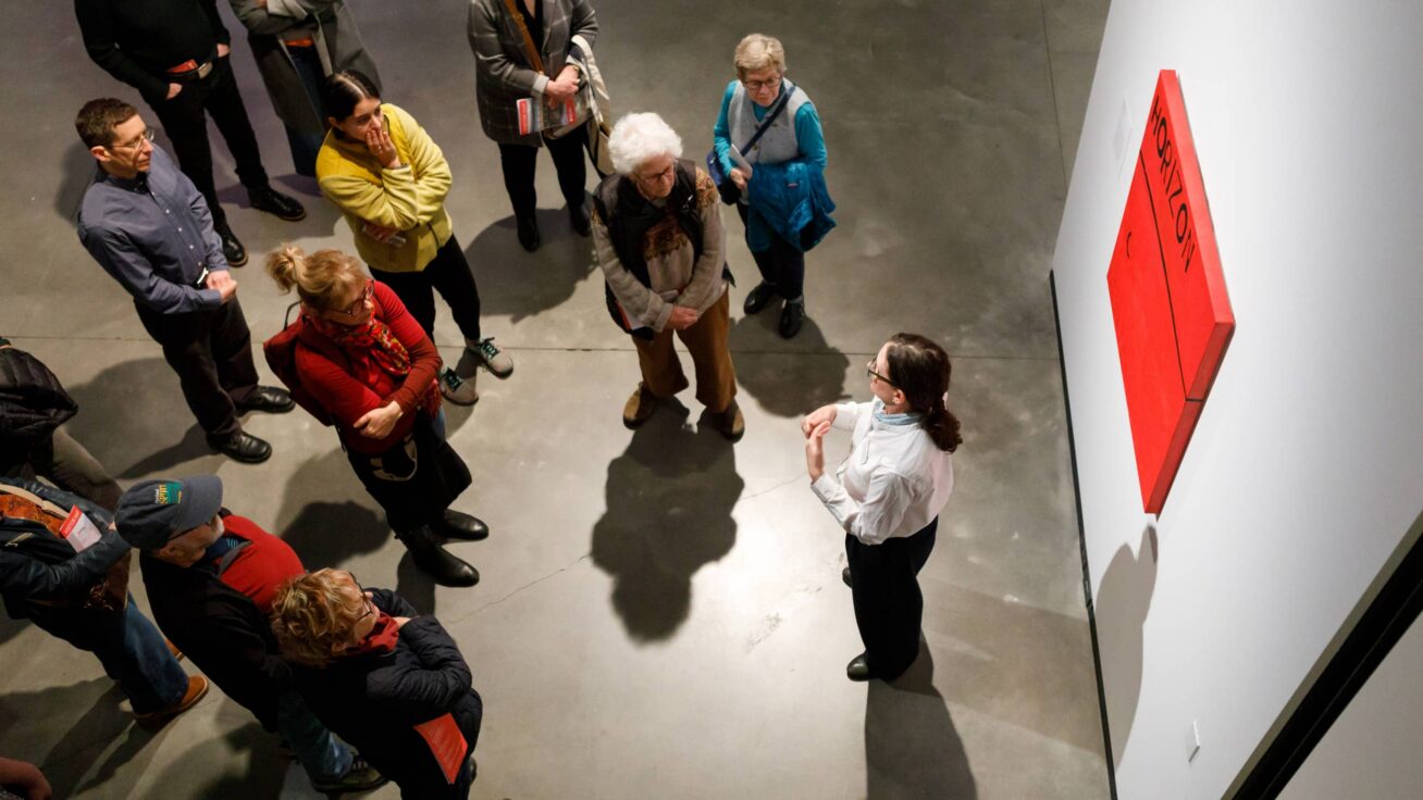 A small group of people in a gallery space.