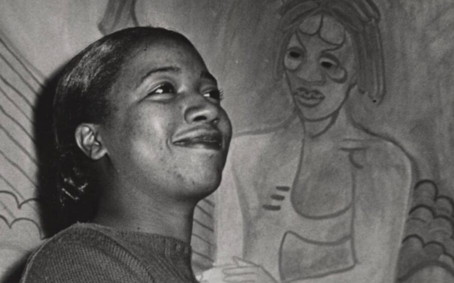 A person standing in front of a painting.