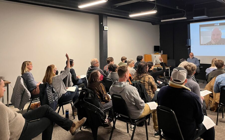 A group of people seated in front of a presenter.