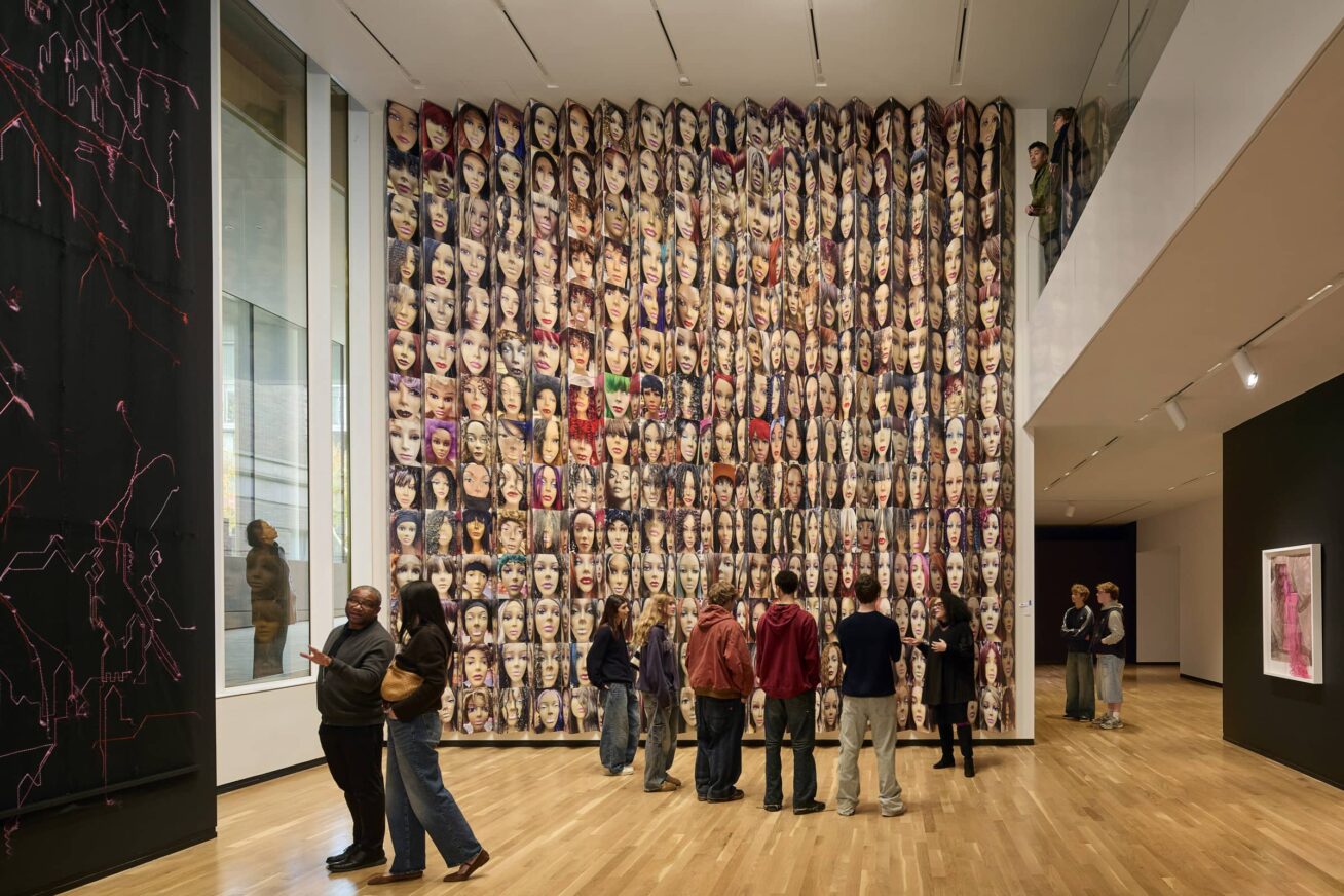 Small groups of people standing in a gallery.