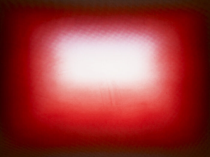 Etching in black and red with a rectangle of white at the center