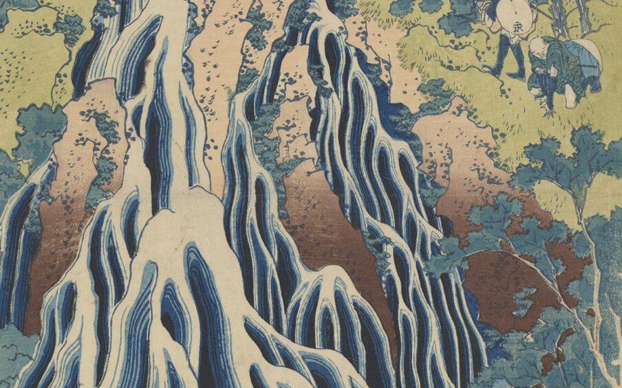 A vertical rectangular portrait of two male figures shown from the waist up wearing 18th century fashions. The figure on the right is seen mostly from the side and seems to be in the act of turning to face the viewer. His hands are outstretched holding a coral bead necklace up to the other figure. He is light skinned with short brown cropped hair under a blue turban-like headdress that is skewed to the left. He is smiling with lips parted and teeth showing and has soft, youthful features. He wears an open neck, collarless white shirt with a reddish-pink coat and a blue shawl draped over his arms and shoulders. White full, gathered sleeves and shirt cuffs extend past his jacket at his wrists. The figure on the left faces the viewer wearing a white ruffled edged mob cap with a pink bow on top, a mustard yellow dress with a pink stomacher and lacing, with a white ruffle seen at the neckline. This figure is light skinned, has short dark hair, heavy brows and an upturned nose. His forehead and face are lined and his mouth is partially open showing he is missing a tooth. His neck is muscular and he has a goiter.