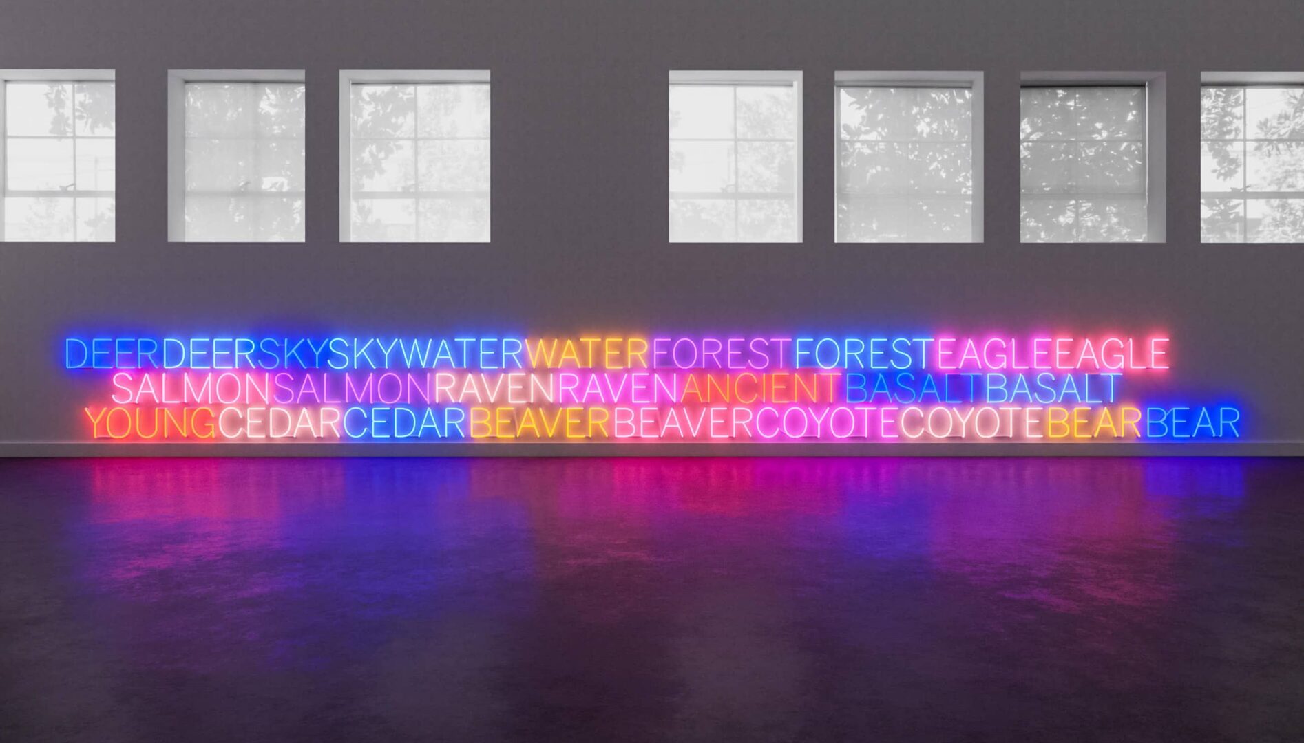 Different colored neon text under a series of gallery windows.