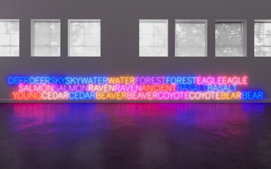 Different colored neon text under a series of gallery windows.