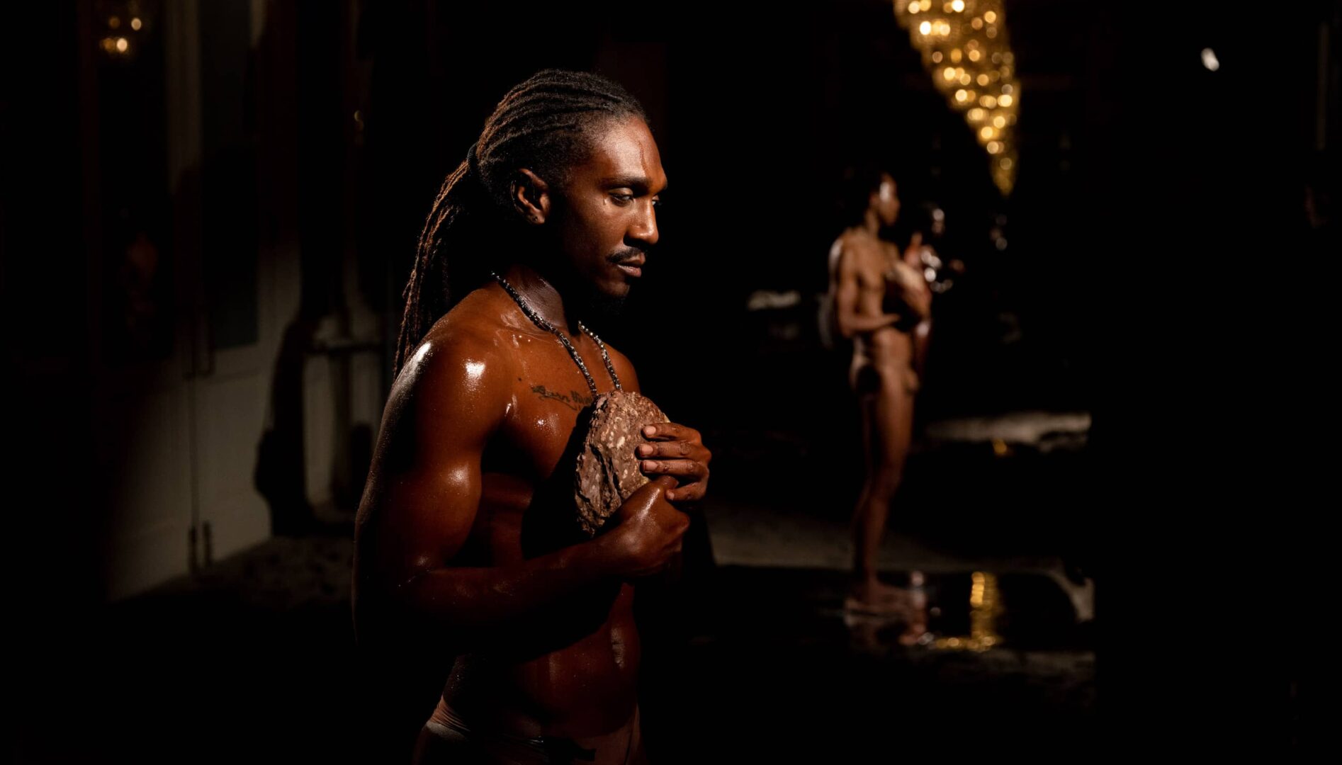 Two people standing in a dark room.