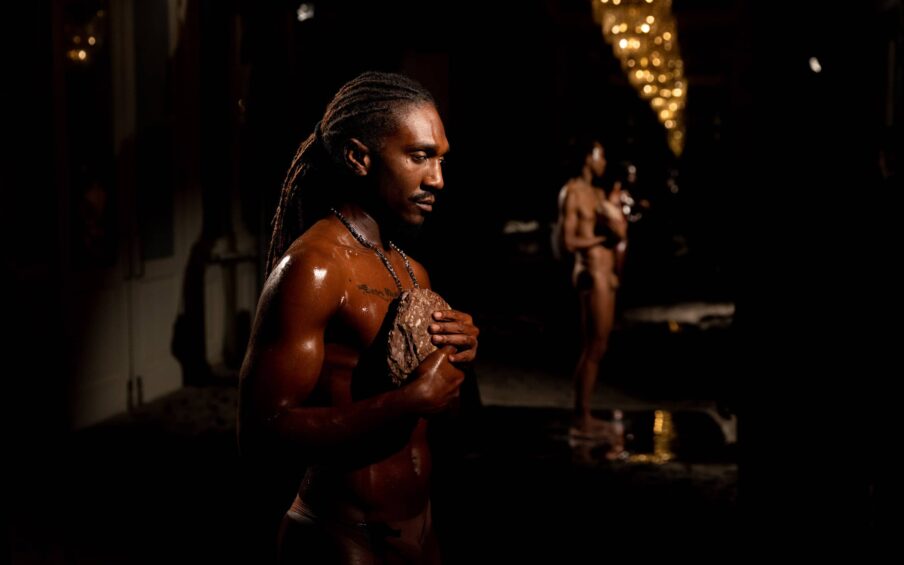 Two people standing in a dark room.