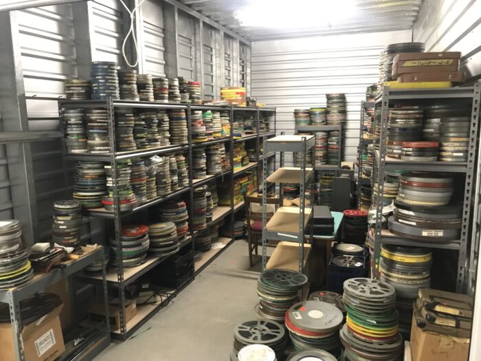 A storage space filled with film reels in canisters.