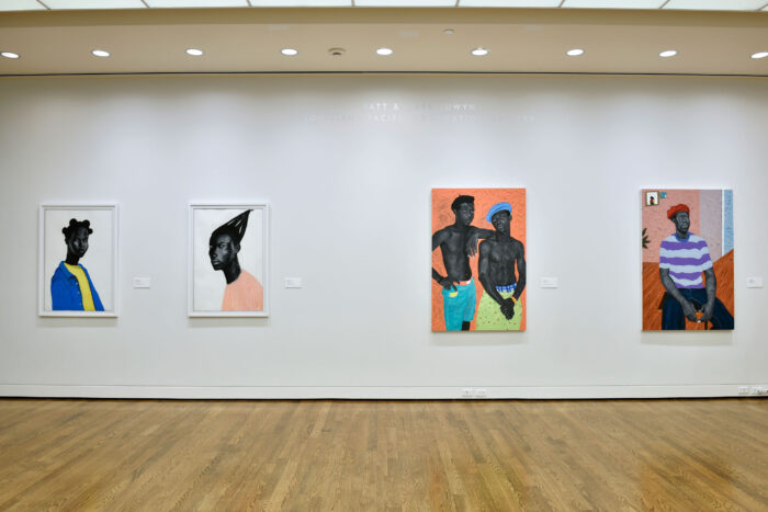 Gallery wall with four paintings by Otis Quaicoe.