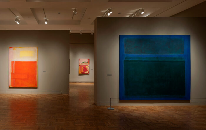 Dimly lit gallery with Mark Rothko paintings