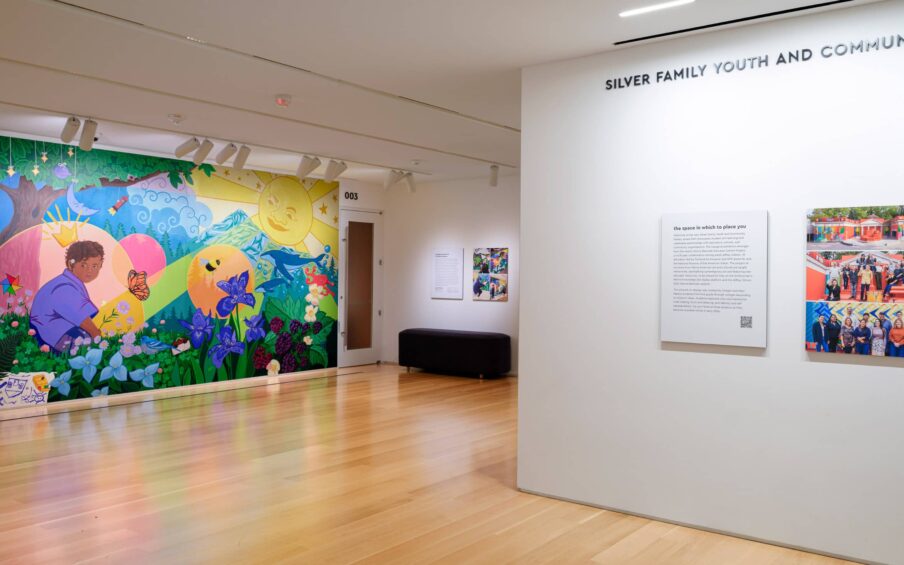 Interior gallery space with a colorful wall mural.