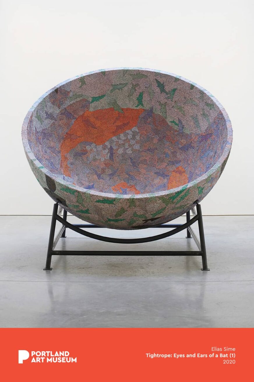 Large, colorful bowl on a metal stand.