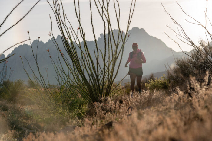 Photo of a desert scene with a person running in the distance