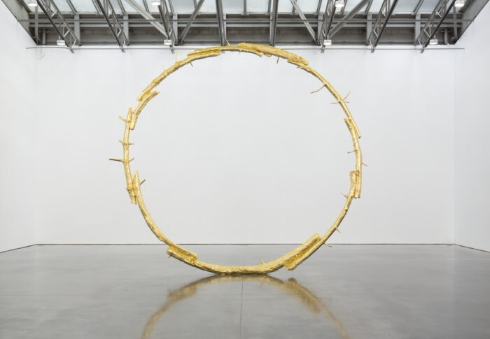 A large bronze sculpture i the shape of a ring.