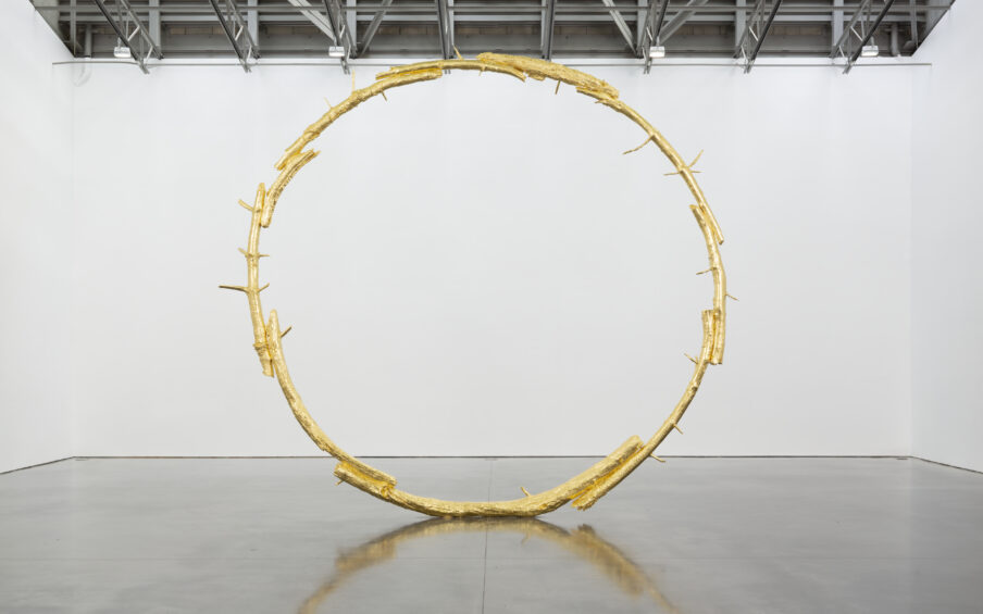 A large bronze sculpture i the shape of a ring.