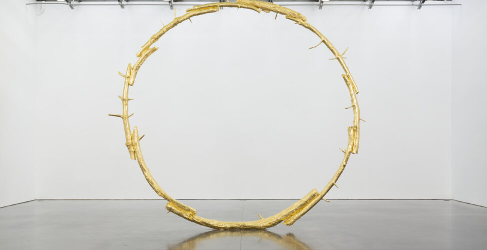 A large bronze sculpture i the shape of a ring.