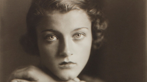 Sepia photograph of a woman leaning her chin on her hand