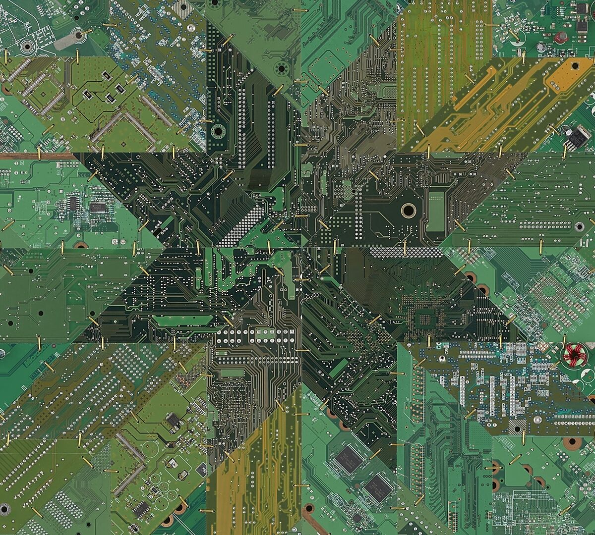 A large square work composed of circuit boards in various shades of green pieced together like a quilt and connected with brass wire.